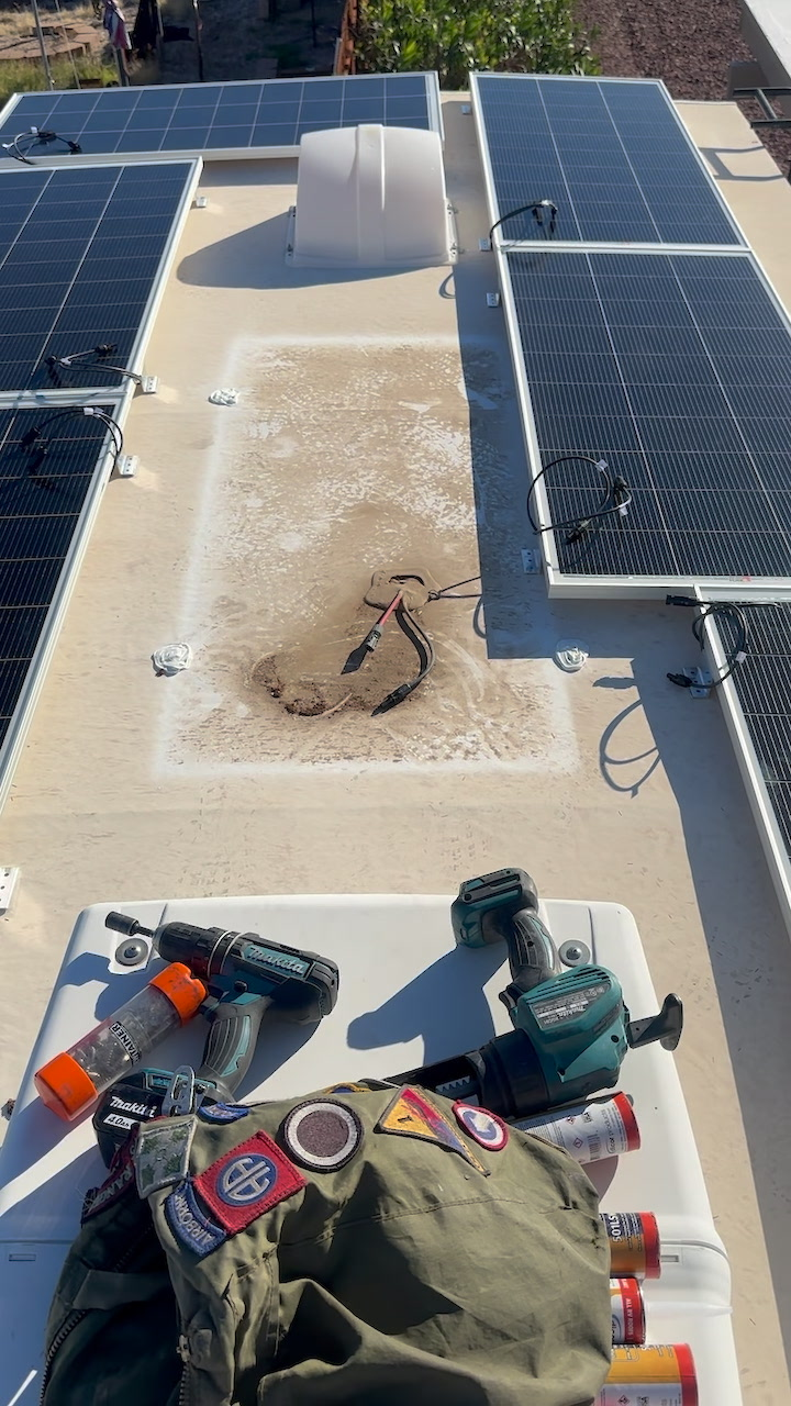Rooftop RV solar panel array with tools during a sizing and layout install