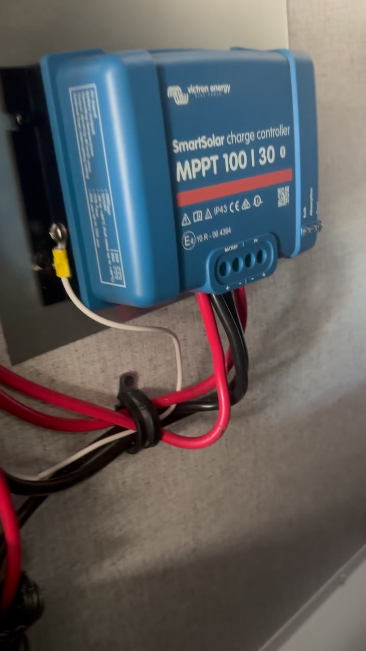 Victron SmartSolar charge controller and wiring being assessed during an inspection